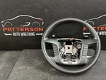 10-12 Ford Taurus Black Leather Wrapped Steering Wheel With Accessory Control. Fixed Price $135.00.